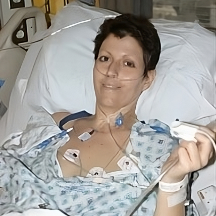 Heather Von St. James recovering in bed after surgery