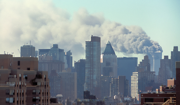 A photo of the Manhattan skyline on 9/11 after the terrorist attack. Smoke billows out of the Twin Towers.